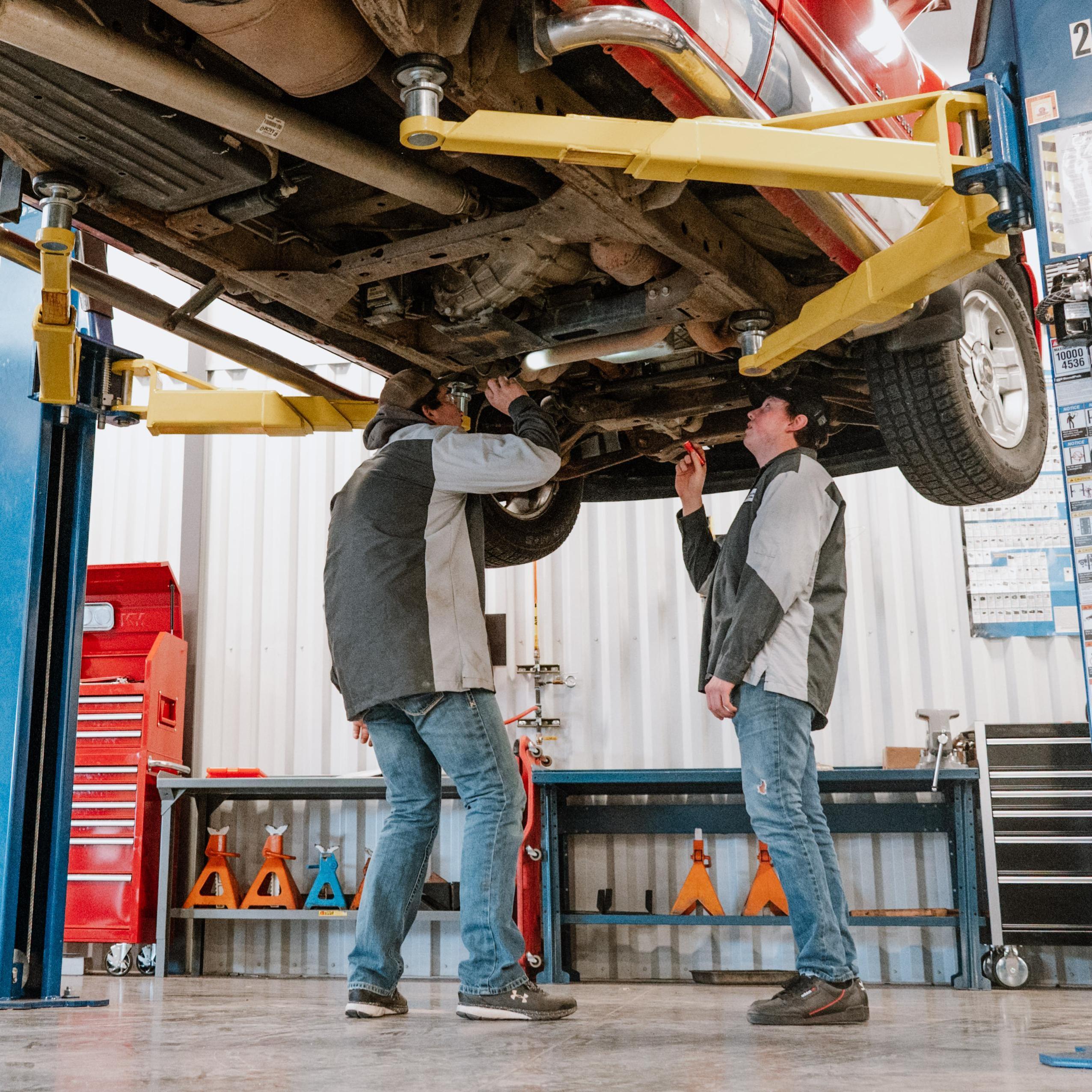 CTE 2 male students working under truck