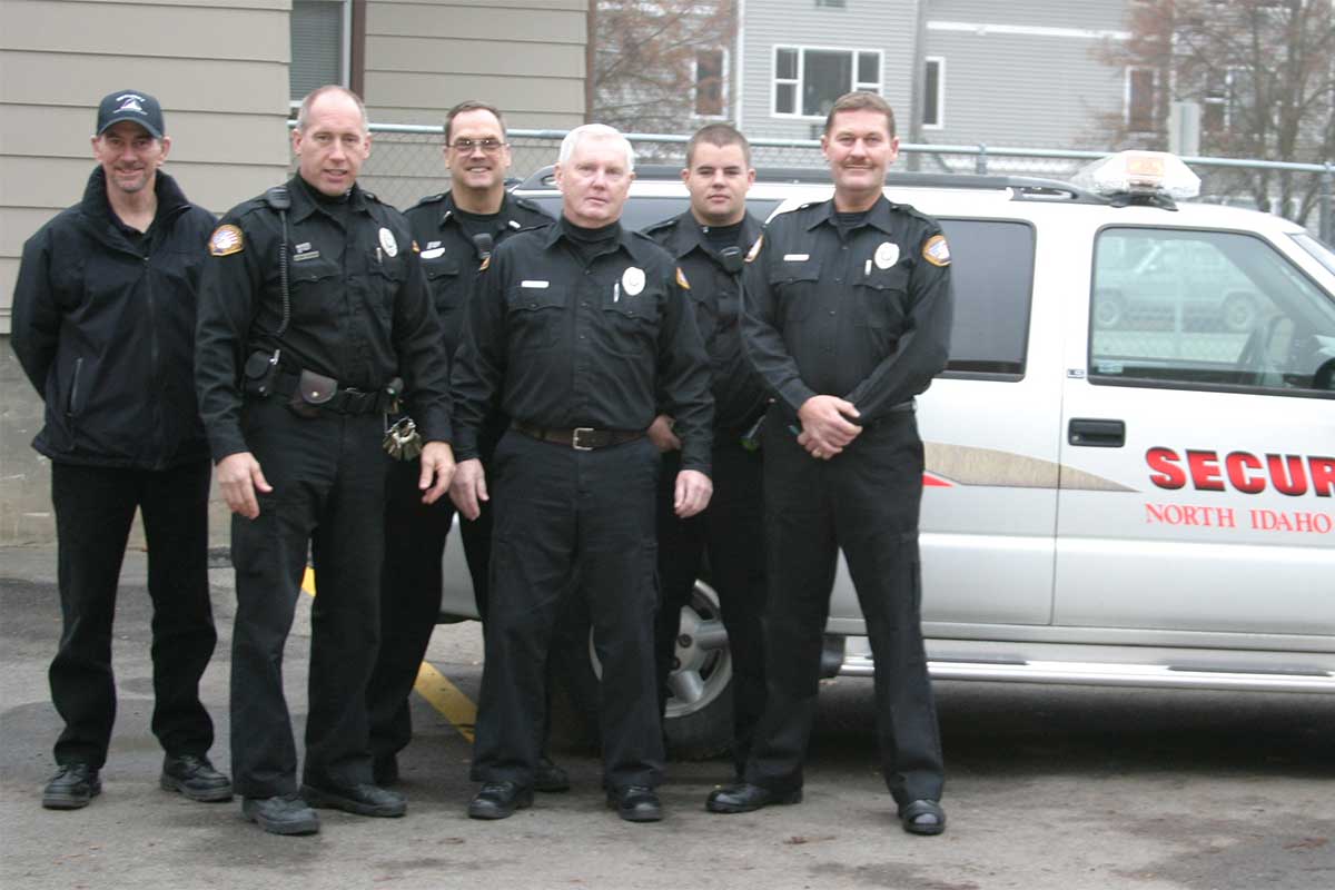 Campus security guards in front of patrol vehicle