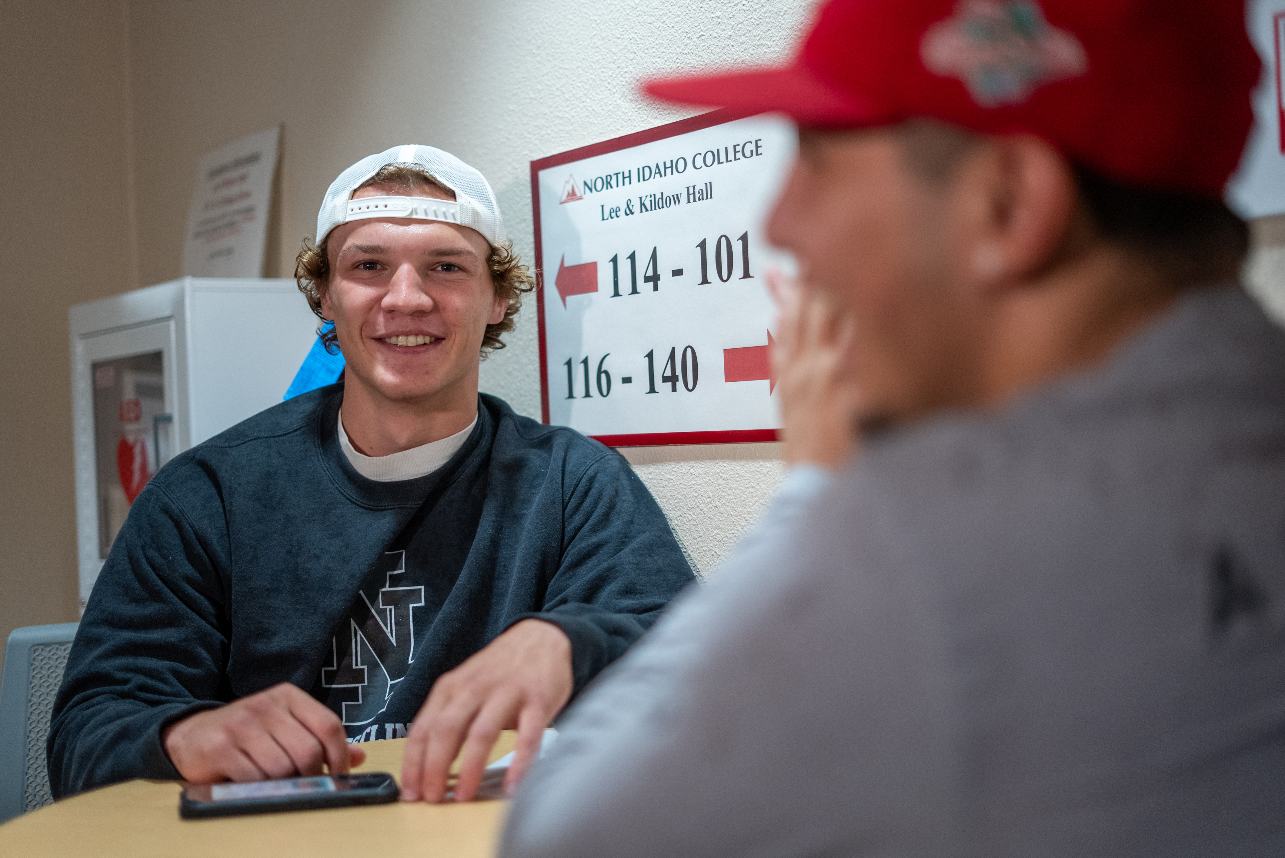 Male student sitting and smiling