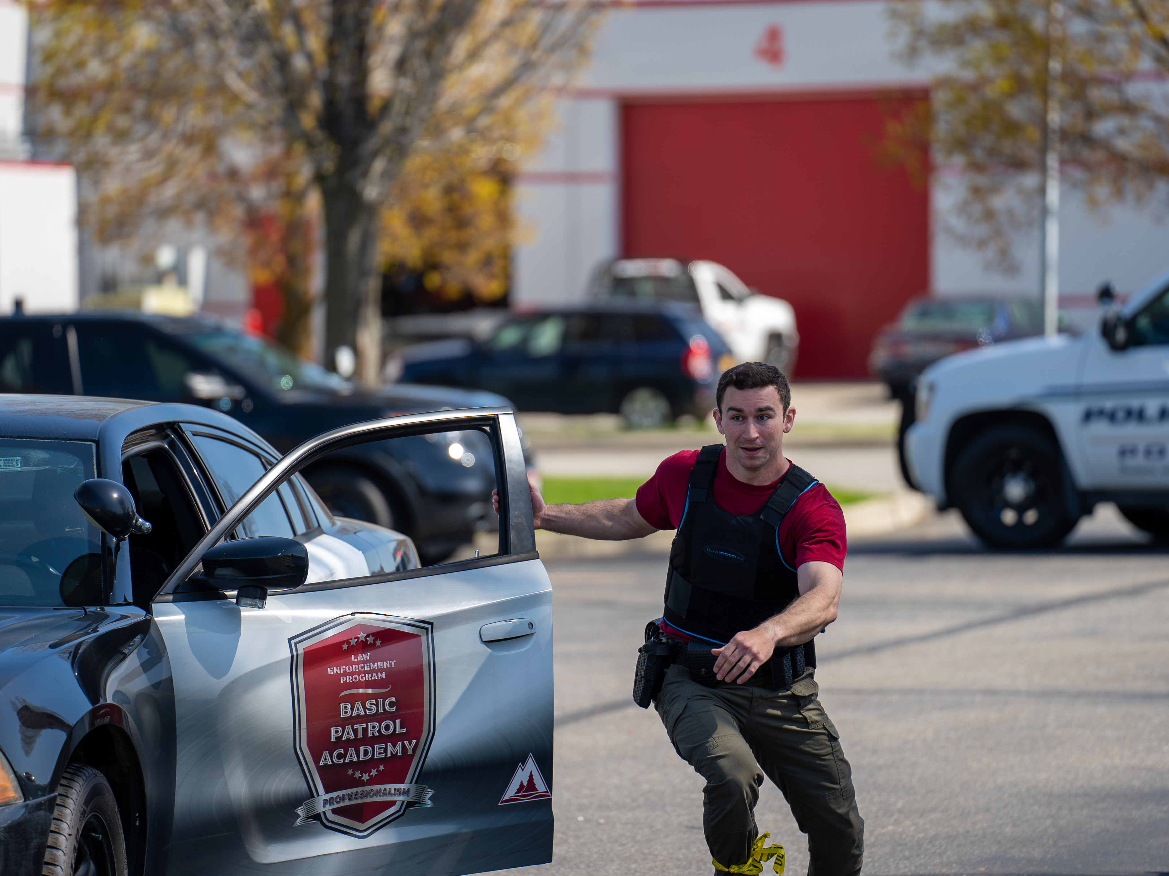 Police academy student running out of patrol car