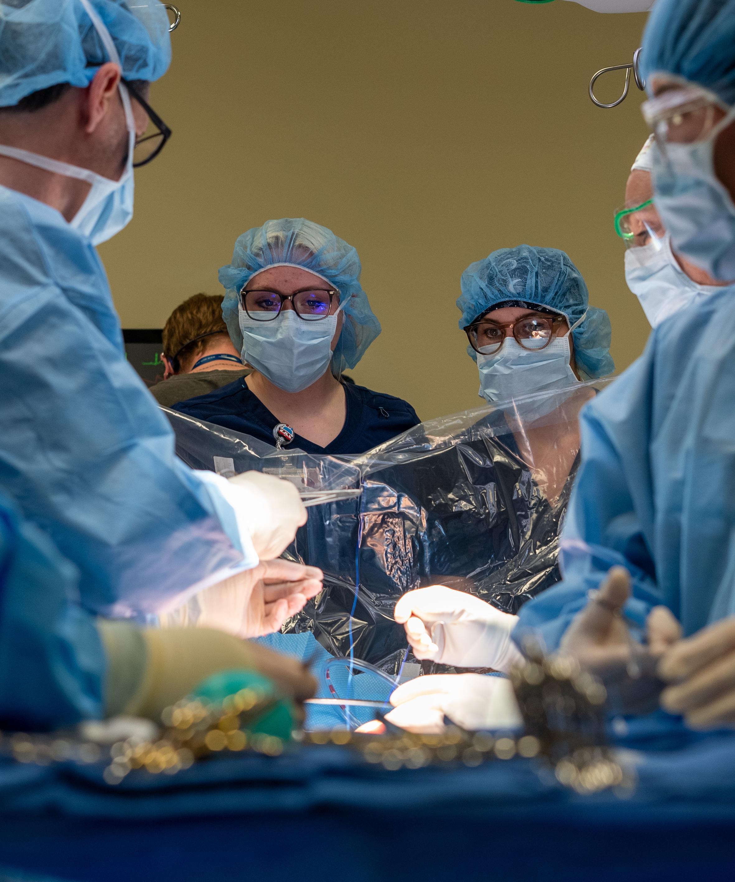 Surg Tech mock surgery with multiple people at the surgery table