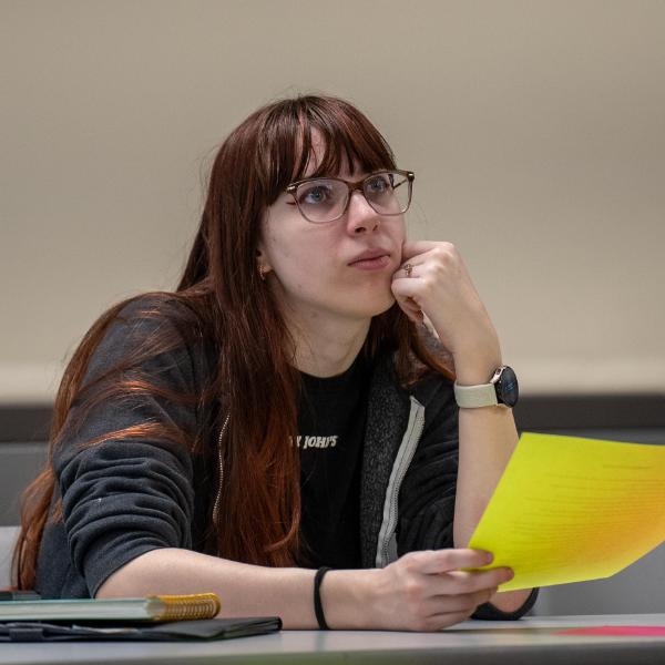 female student in class paying attention to teacher