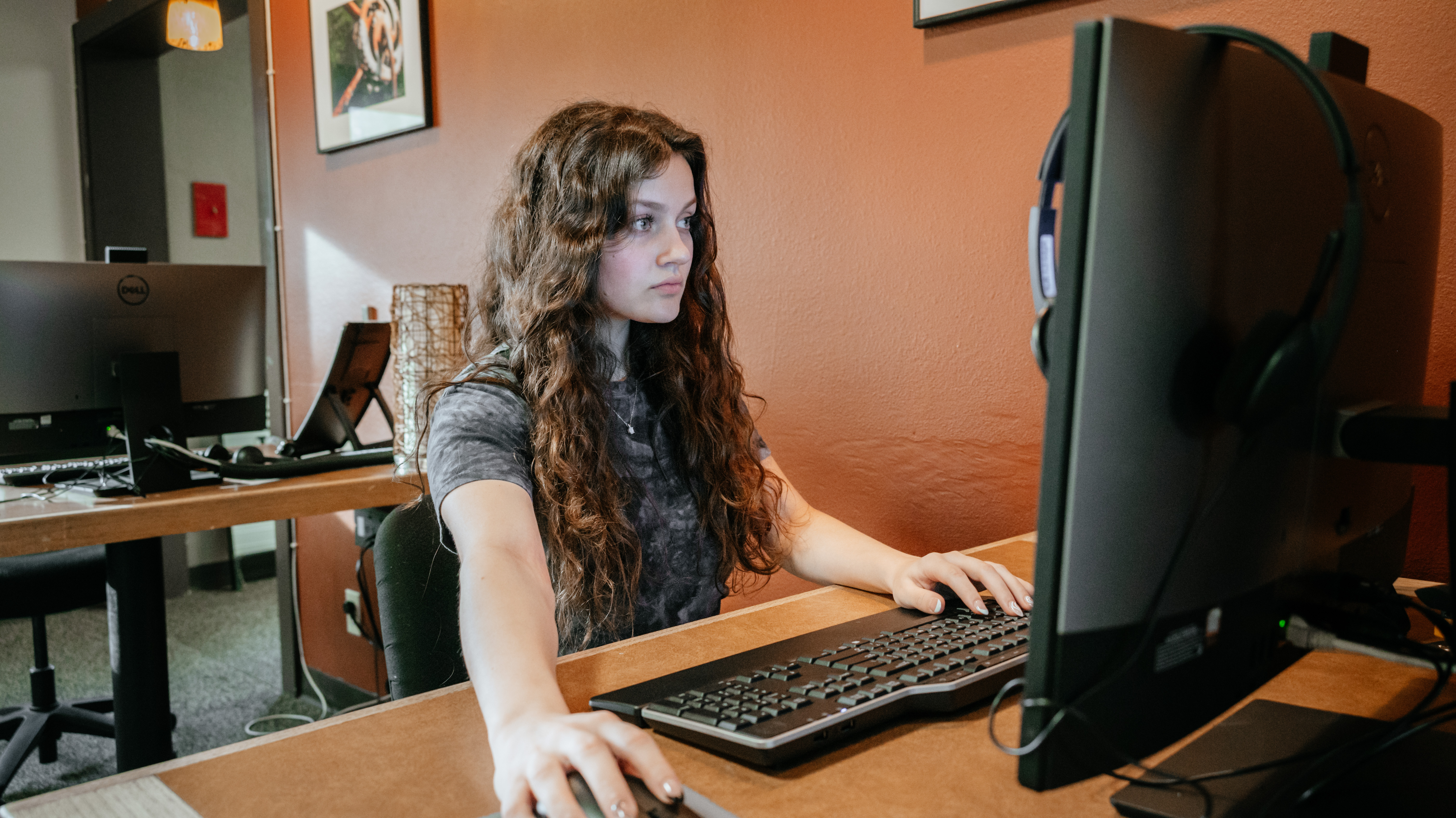student at desk working at computer
