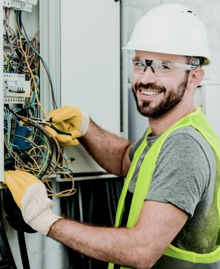 Cover Photo of 2023 Catalog of man working an electrical panel