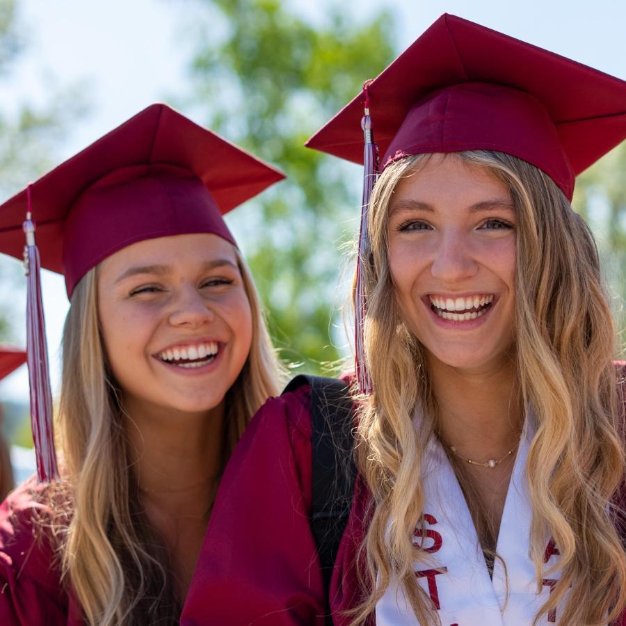 3 female graduates in cap and gown