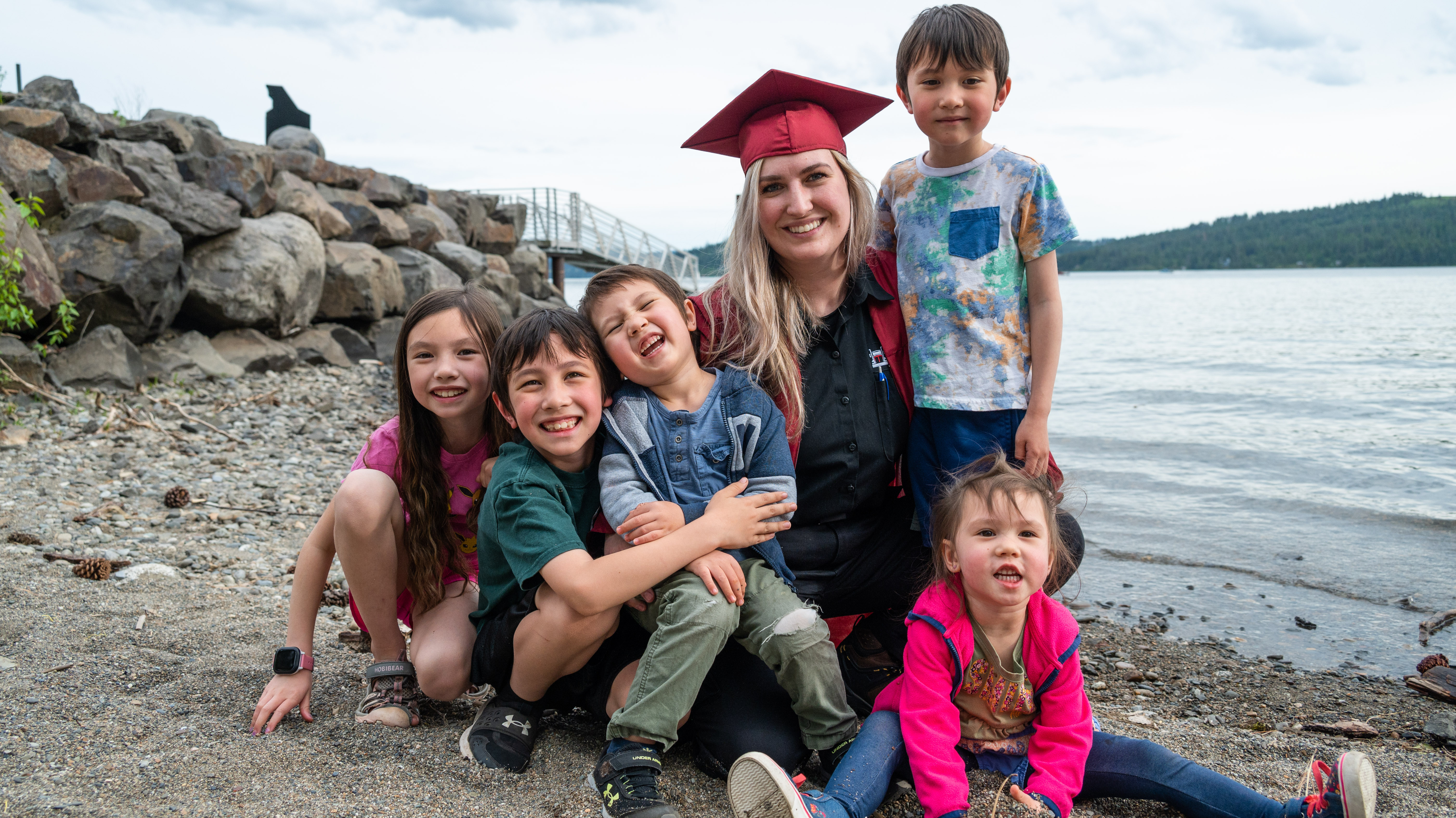 CND Grant Graduate with family on the shore of the lake