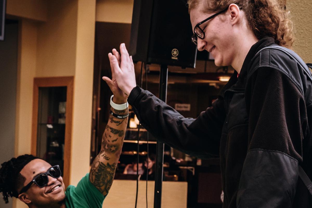 1200x800 Student Support Green Dot St Paddy's Day Event, two students giving a high five