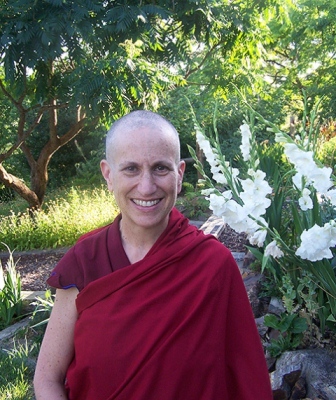 Venerable Thubten Chodron in front of flowers