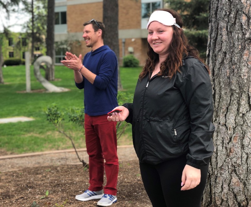 Student Holly Tomason smiles, while instructor Aaron Cloyd claps