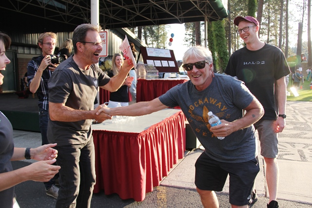 Really BIG Raffle winner shaking hands with the college president