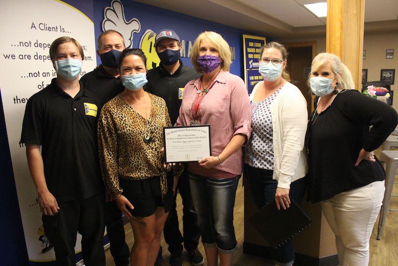 Members of the apprenticeship program holding an award