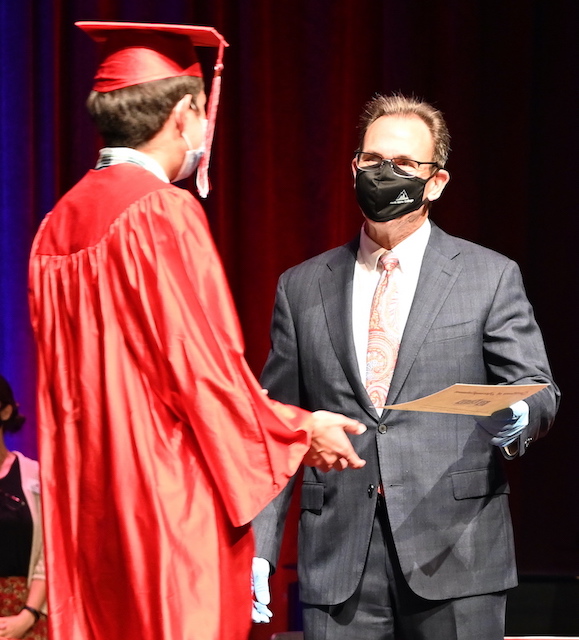 NIC President shaking GED grads hand