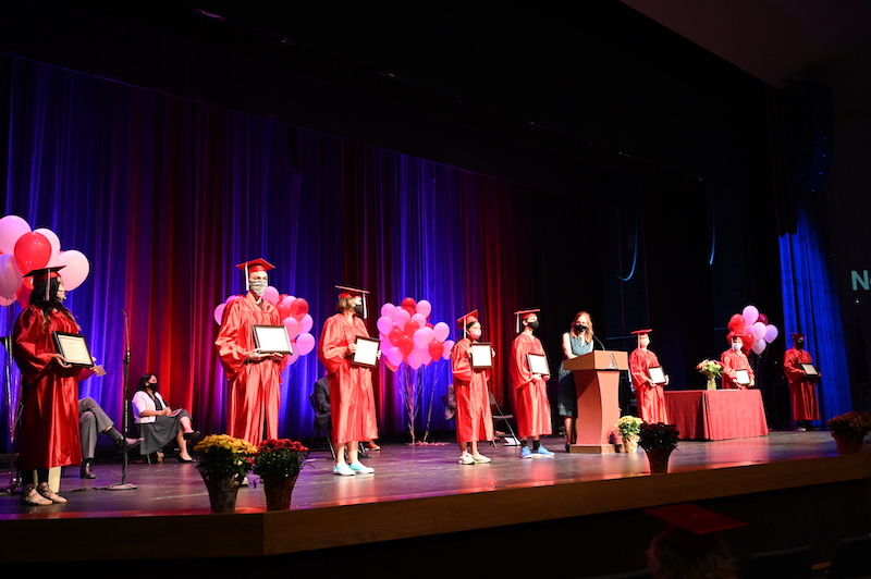 GED Grads line up on the stage