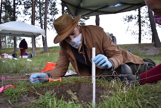 Student examining archaeology site