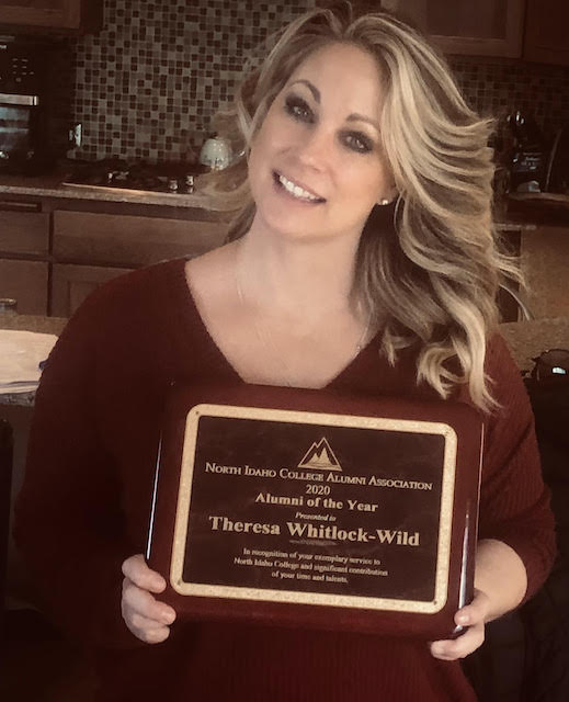 Theresa Whitlock holding a plaque