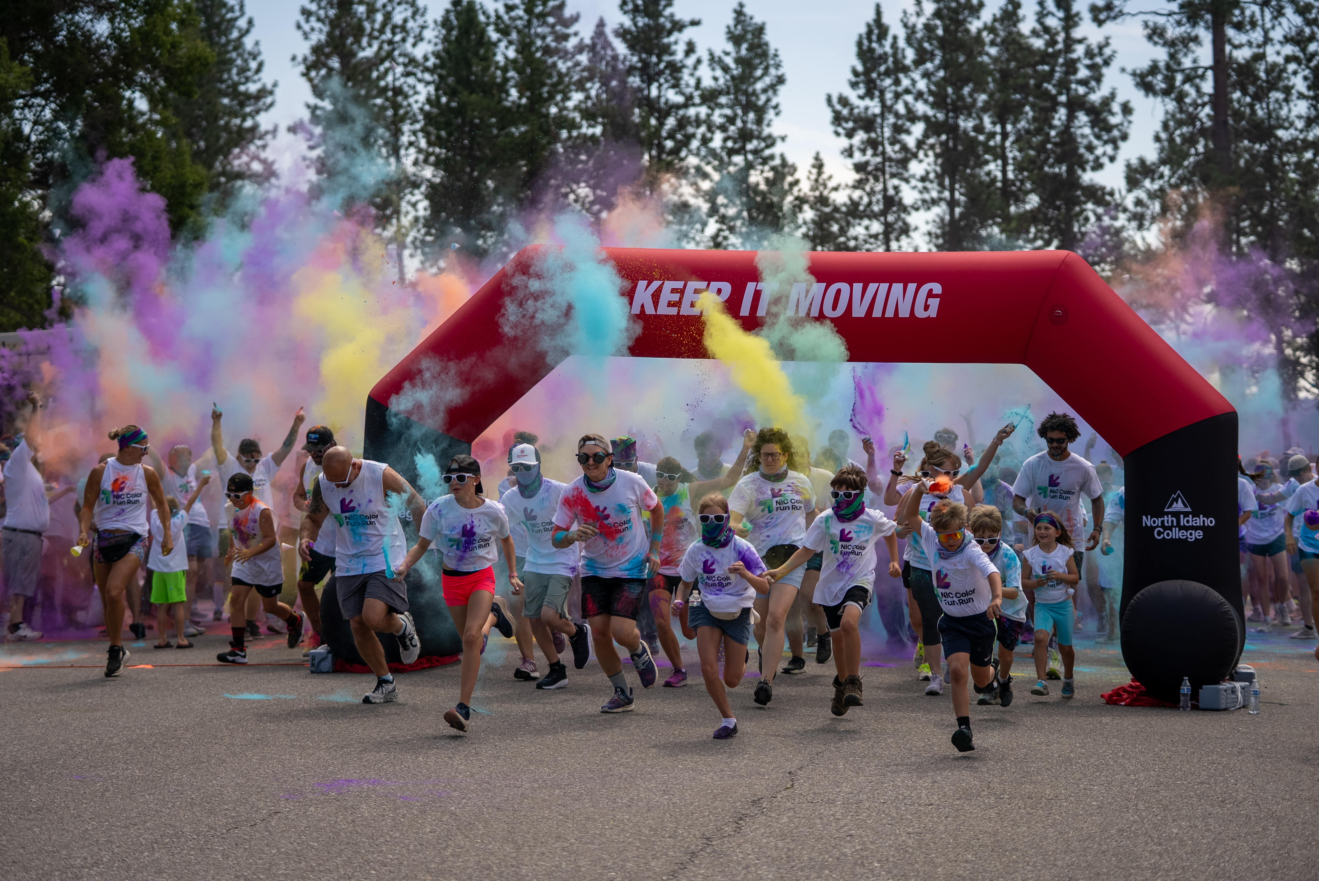 Participants run through the start line of the inaugural NIC Color Fun Run on Aug. 23, 2025.