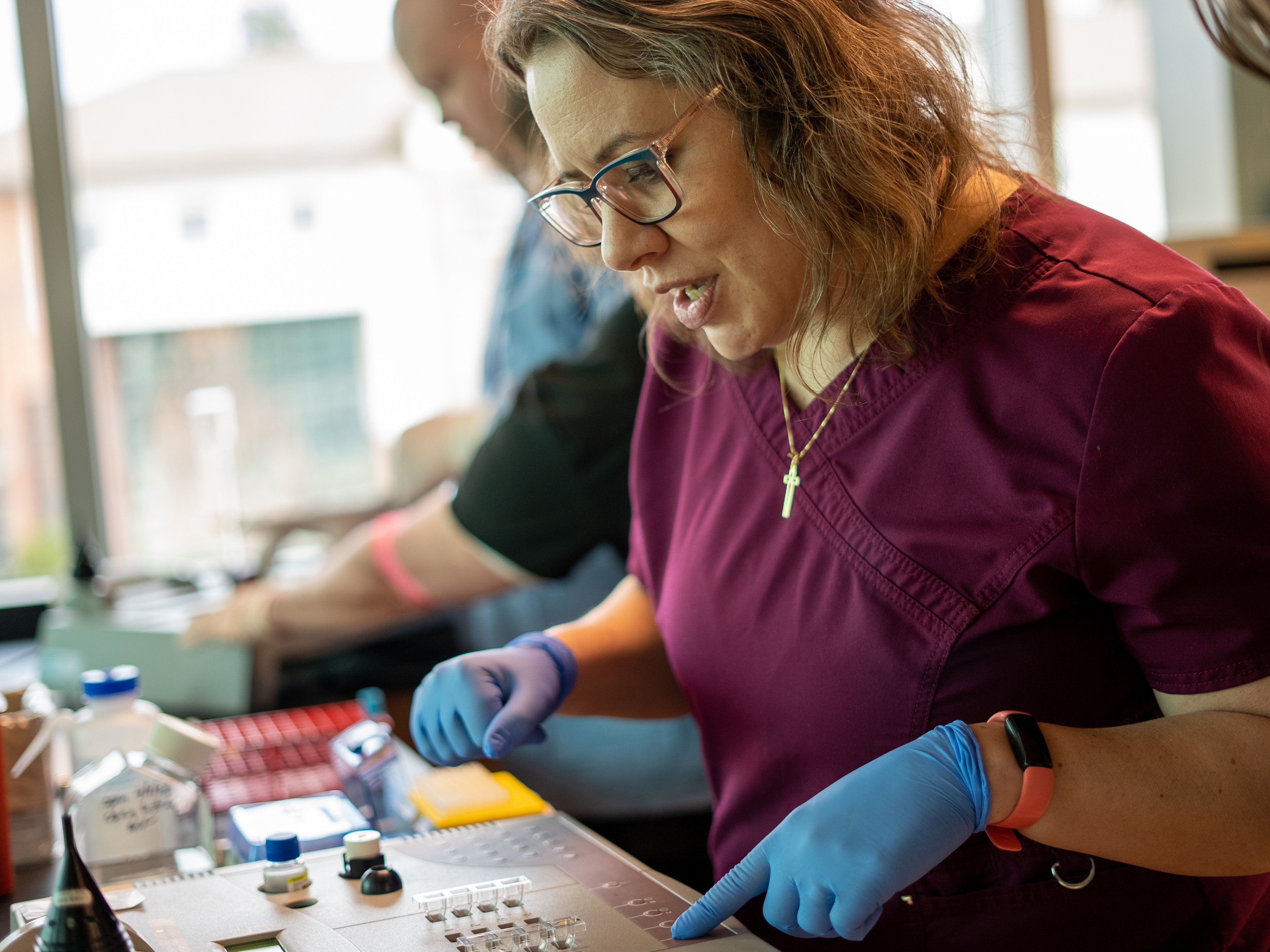 Nurse looking at some type of med equipment