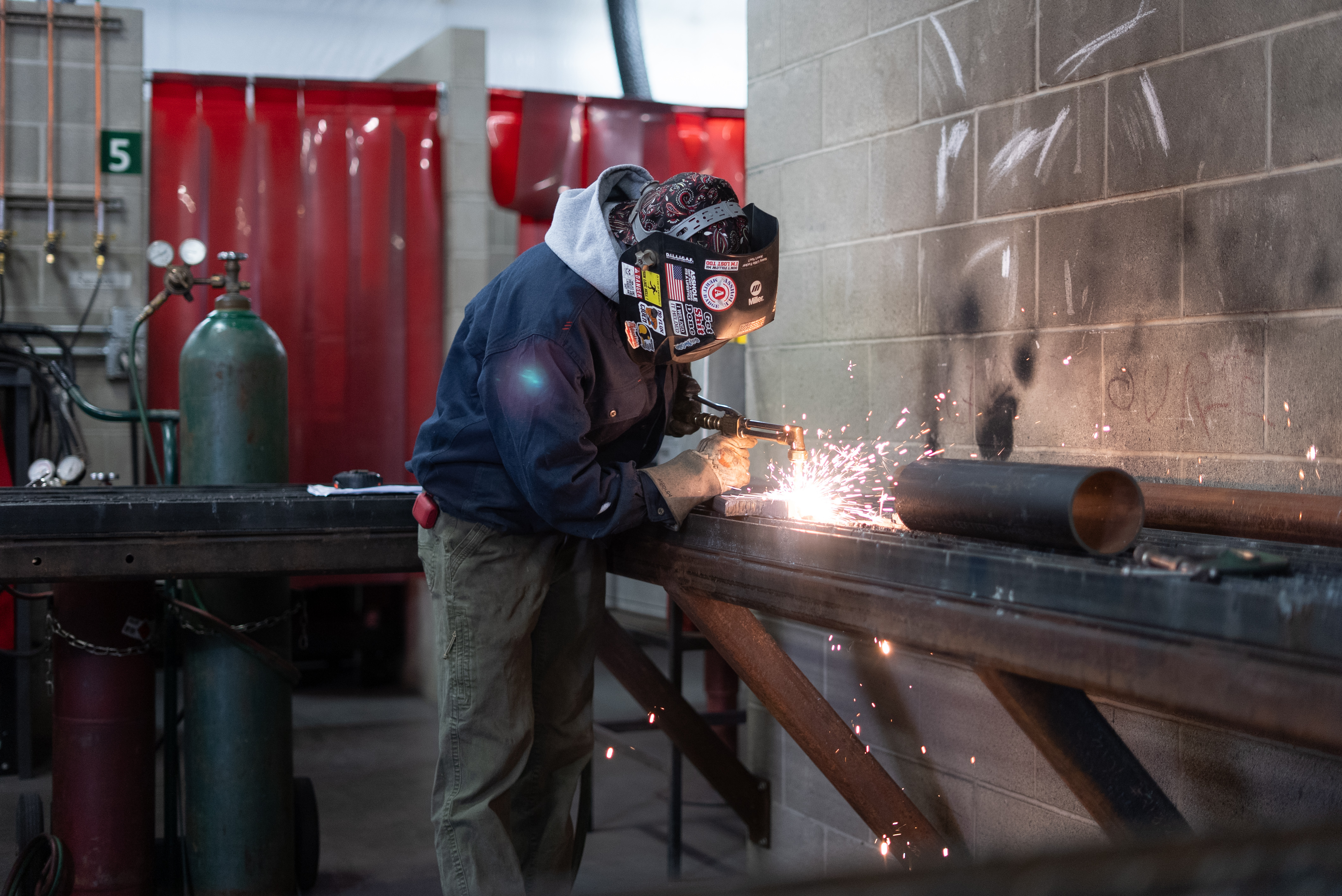 student welding on a table in welding class