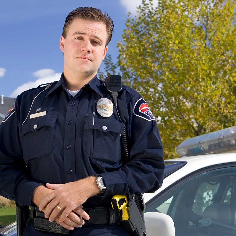 Police Officer standing outside of his vehicle