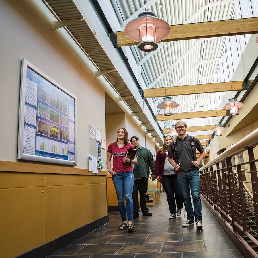 Group of students walking down a hallway