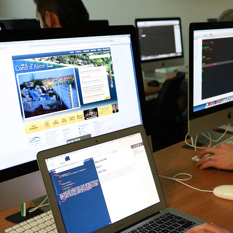 Student designing a website on an iMac