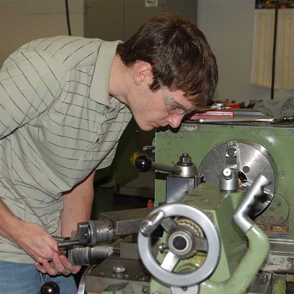 CNC Technology student working with CNC Machine