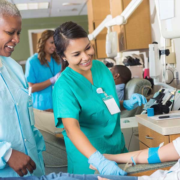Medical assistant working with a patient