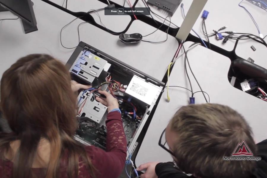 Students working on the inside of a computer