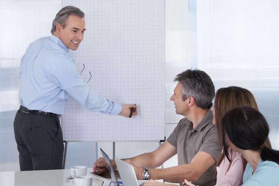 Business people in meeting with whiteboard