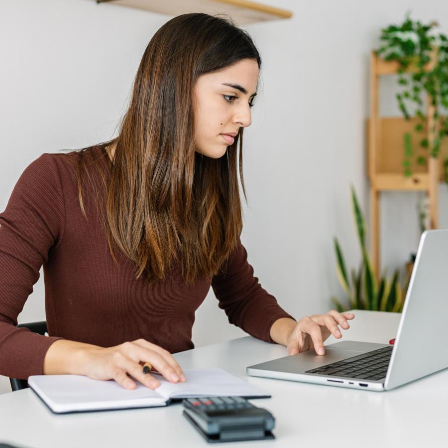 900x900 young professional business woman working on laptop